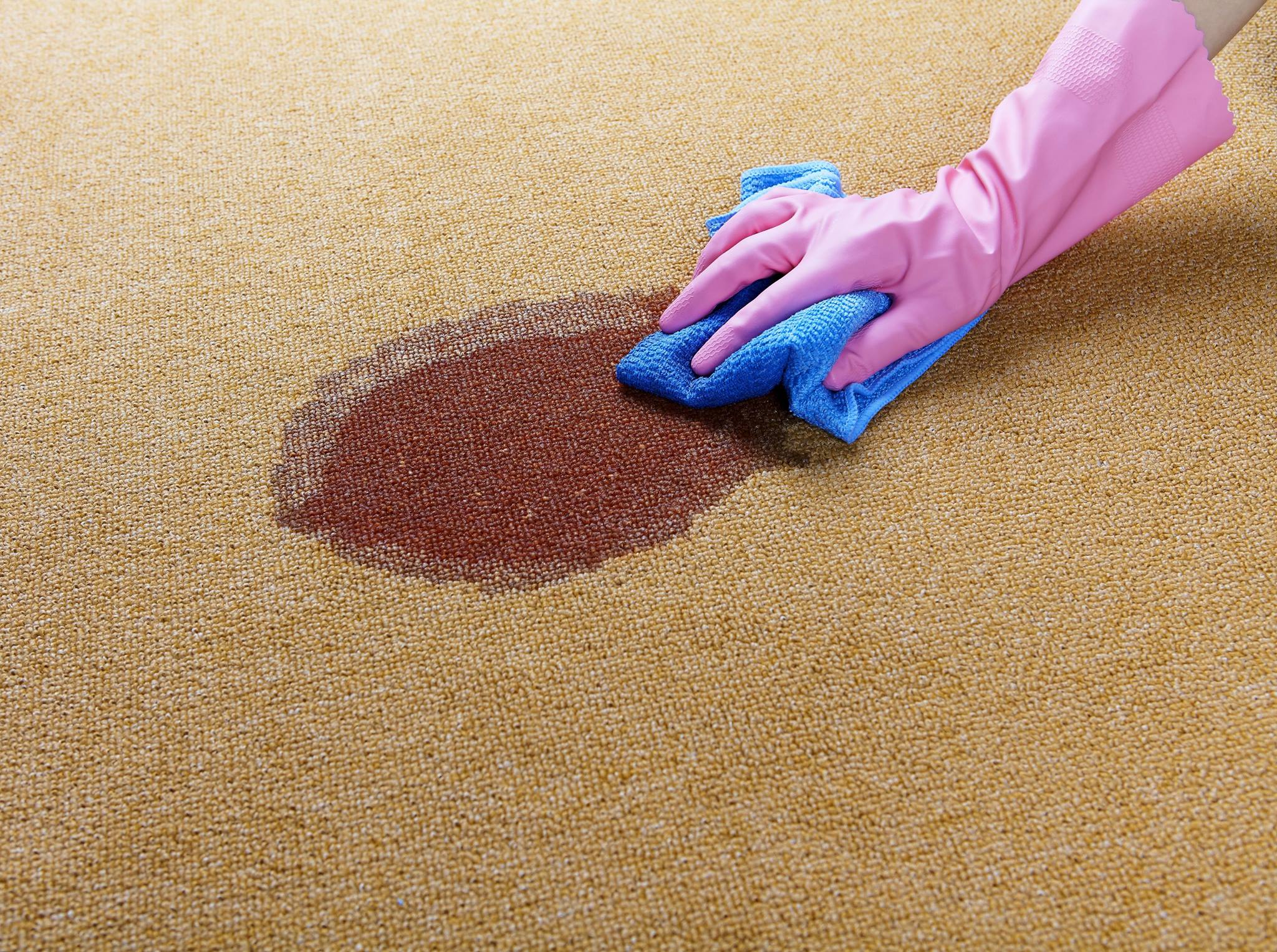 Male hand with the rubber applies grout on a seam between tiles @fname@